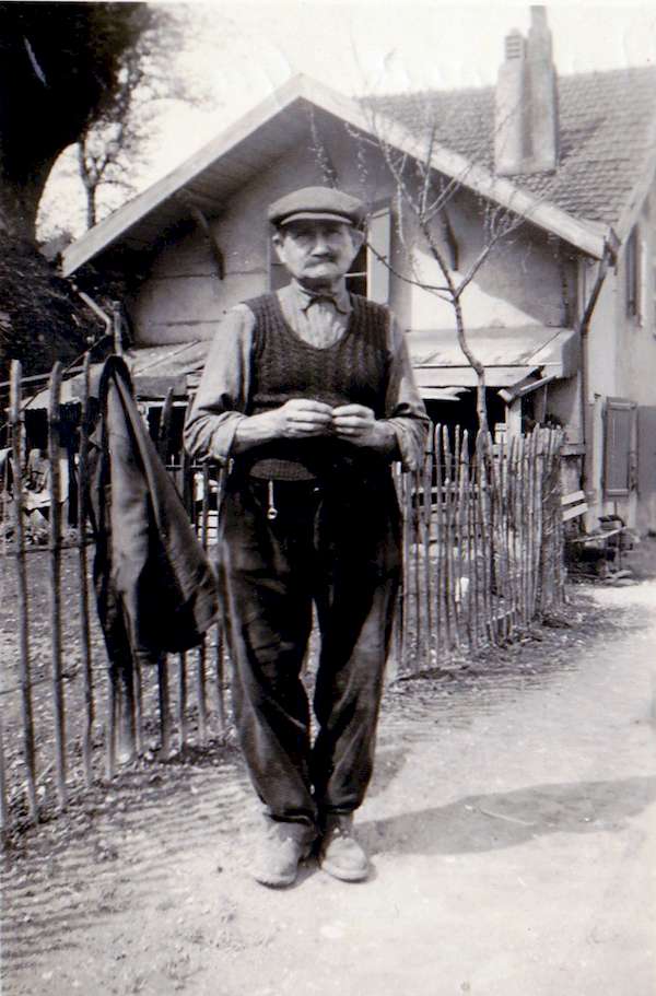Photo d'Antonin Gaillard roulant une cigarette devant son jardin